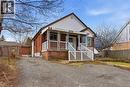 Brick and siding exterior with a covered front porch featuring white railing and a striped awning - 880 Lawrence Road, Hamilton, ON 