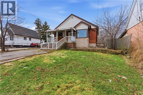Red brick and white siding exterior with a pitched roof - 880 Lawrence Road, Hamilton, ON 