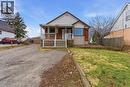 Brick and siding exterior featuring a covered front porch with white railings, and a prominent front-facing window - 880 Lawrence Road, Hamilton, ON 
