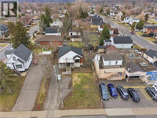 Single-family residence featuring a front porch with white railing, a gabled roof, and a visible side entrance - 880 Lawrence Road, Hamilton, ON 