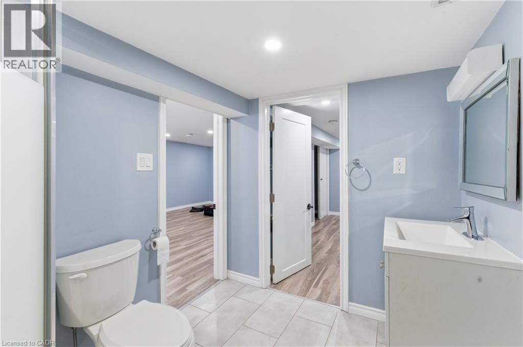 Bathroom featuring light blue walls, white trim, and light grey tile flooring - 880 Lawrence Road, Hamilton, ON