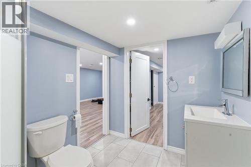Bathroom featuring light blue walls, white trim, and light grey tile flooring - 880 Lawrence Road, Hamilton, ON 