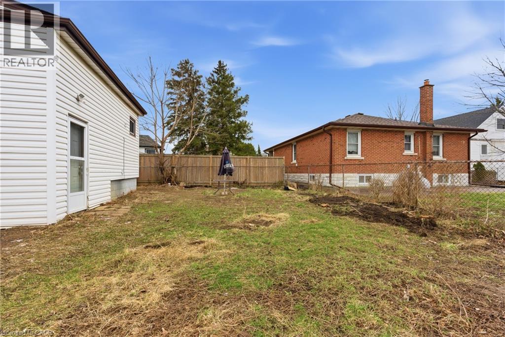Expansive backyard with a mix of grass and natural ground cover - 880 Lawrence Road, Hamilton, ON