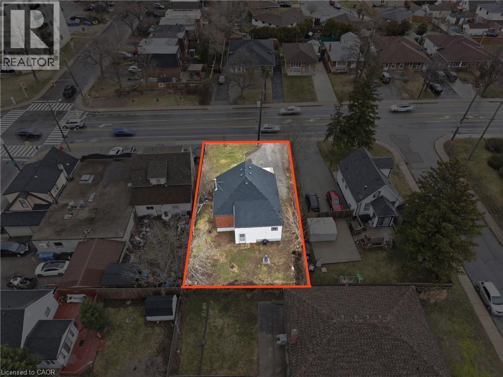 Aerial perspective showcasing a single-family residence with white siding and a dark shingle roof - 880 Lawrence Road, Hamilton, ON