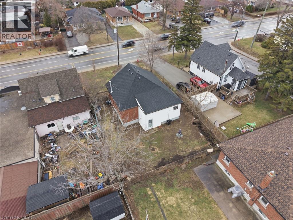 Aerial perspective showcasing a residential property with a dark shingle roof and white siding - 880 Lawrence Road, Hamilton, ON