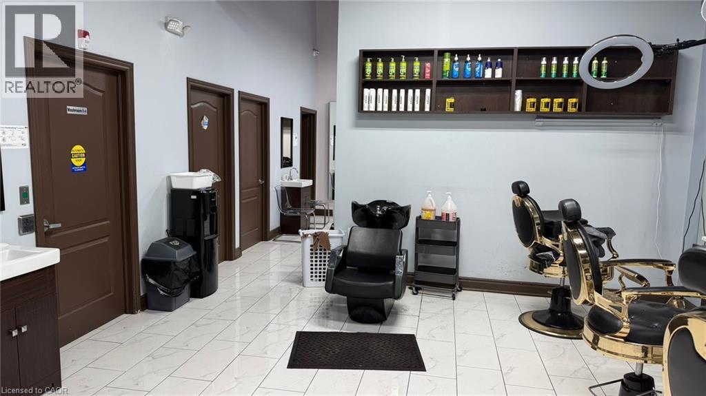 Commercial interior featuring light-colored tile flooring, multiple dark brown doors, and light blue wall paint - 9 Beaumaris Drive Unit# B4, Brampton, ON