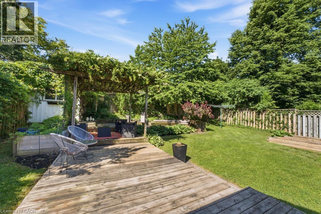 Expansive wooden deck leading to a covered pergola area - 14 Gateway Drive, Guelph, ON