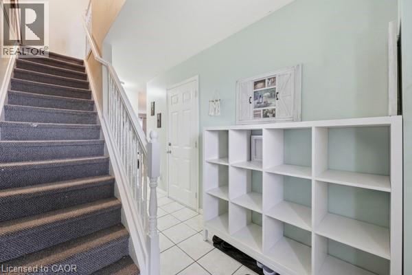 Carpeted staircase with white balusters - 16 Harrison Avenue, Hamilton, ON