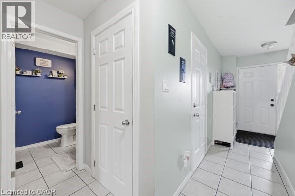 Entryway with white tile flooring and light gray walls - 16 Harrison Avenue, Hamilton, ON