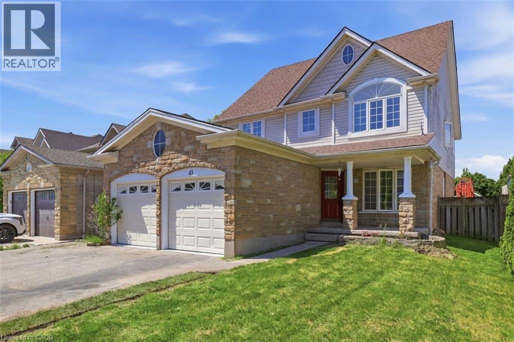 Stone and siding exterior with a prominent front entrance featuring a red door - 43 Decaro Crescent, Cambridge, ON