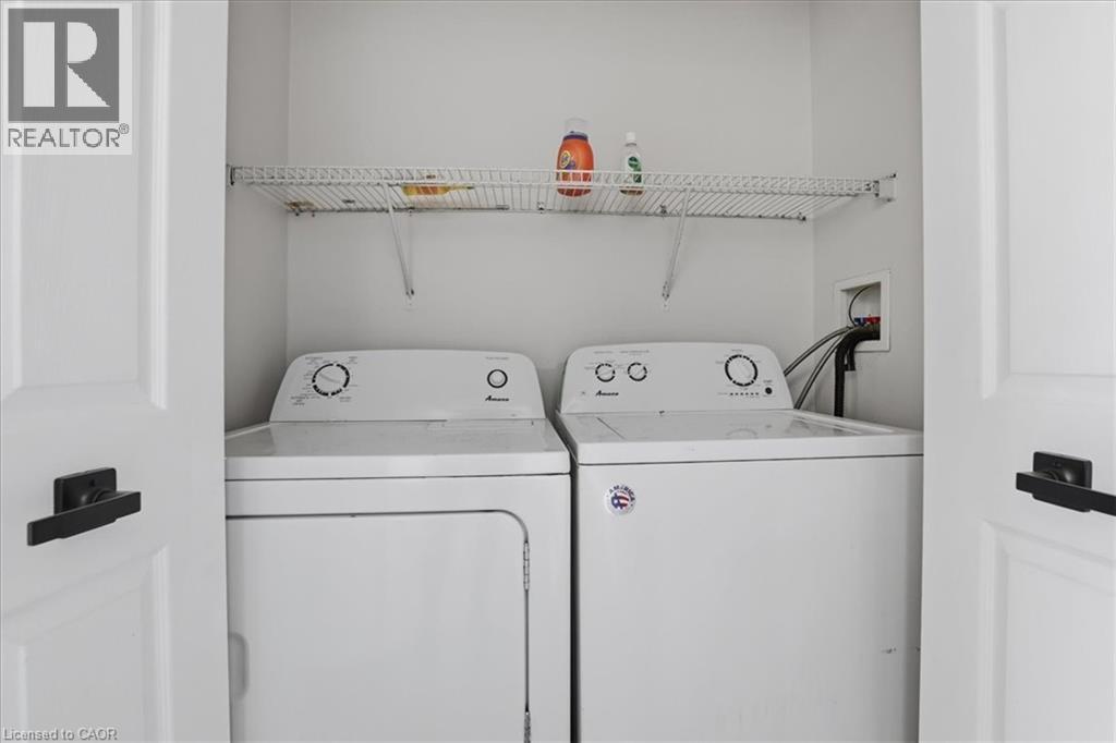 Dedicated laundry closet featuring a top-load washer and front-load dryer - 43 Decaro Crescent, Cambridge, ON