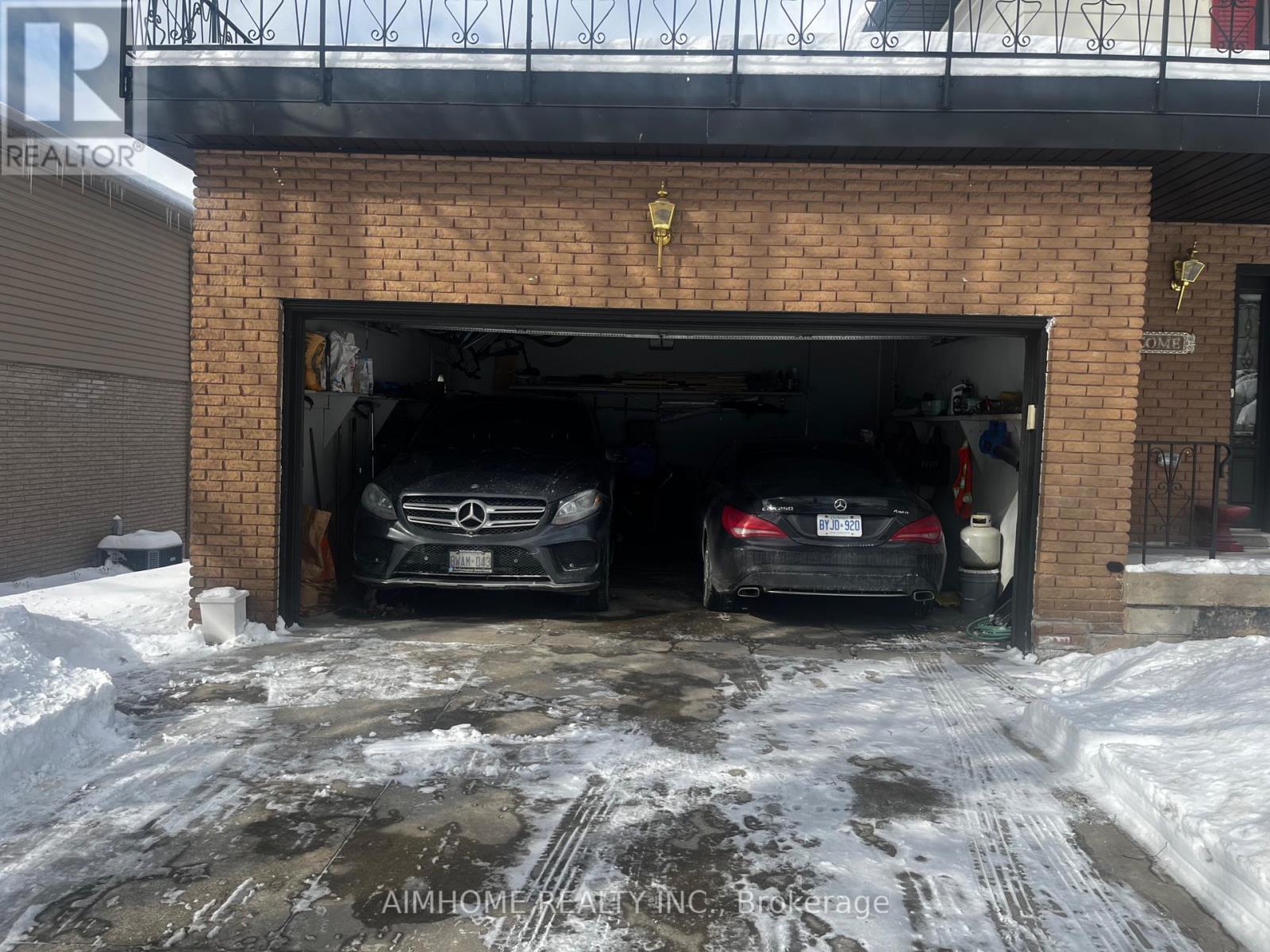 The garage with two cars in. - 23 Hildegard Drive, Hamilton, ON