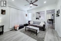 Open-concept living area featuring light wood-finish flooring, recessed lighting, and a ceiling fan -
