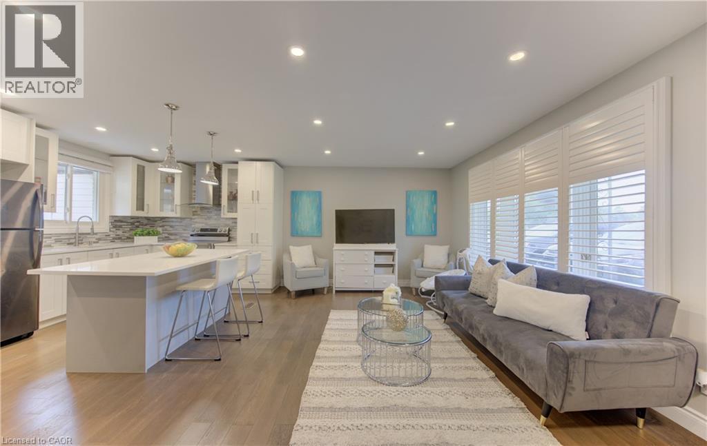 Open-concept living space featuring wood-finish flooring throughout - 619 Forest Hill Drive, Kitchener, ON
