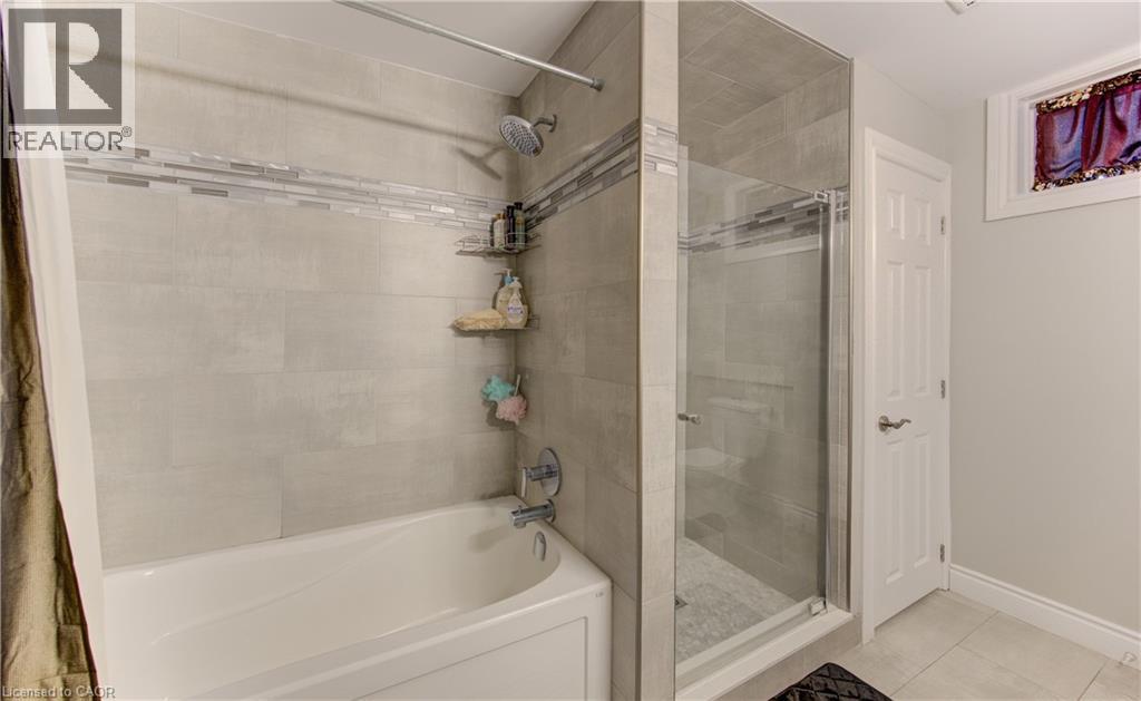 Bathroom featuring a combination bathtub and walk-in shower with glass enclosure - 619 Forest Hill Drive, Kitchener, ON