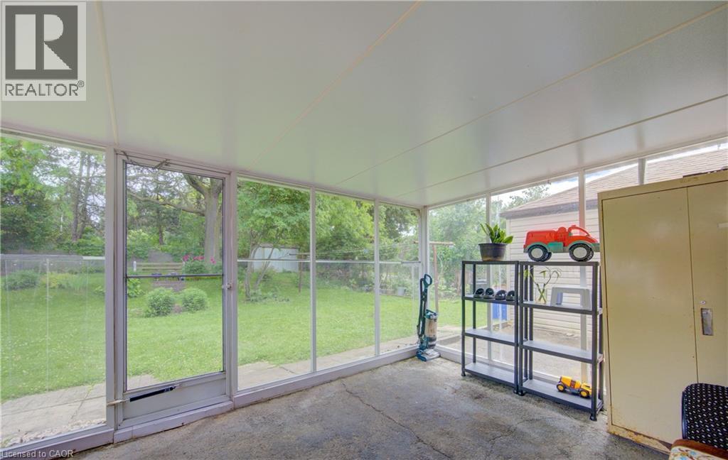 Screened-in patio with concrete flooring and a white paneled ceiling - 619 Forest Hill Drive, Kitchener, ON