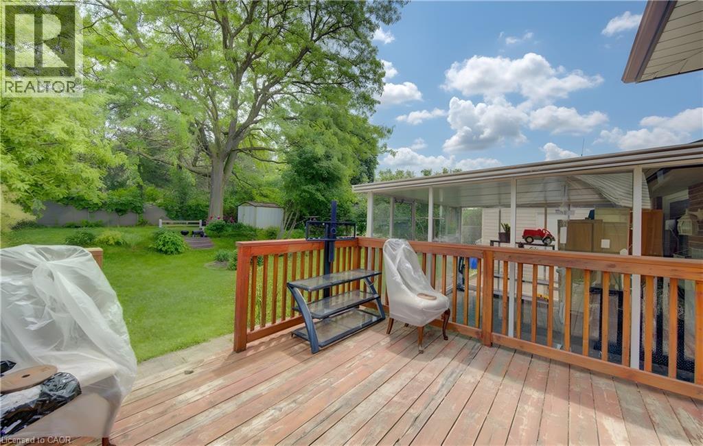 Spacious outdoor deck with wood-finish flooring and a matching wooden railing - 619 Forest Hill Drive, Kitchener, ON