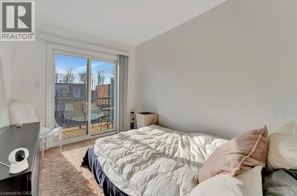 Room with sliding glass doors opening to an exterior balcony - 236 Rachel Crescent Unit# E, Kitchener, ON