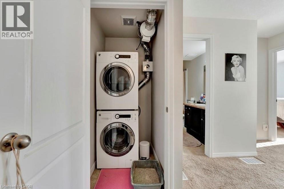 Dedicated laundry closet featuring a stacked washer and dryer - 236 Rachel Crescent Unit# E, Kitchener, ON