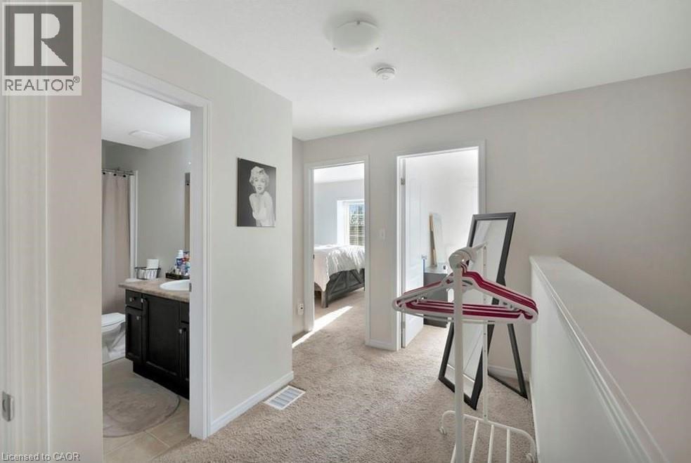 Upper-level hallway featuring light-toned carpeting and neutral wall paint - 236 Rachel Crescent Unit# E, Kitchener, ON