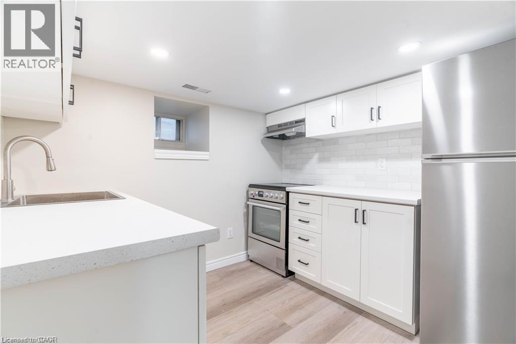 Modern kitchen with white cabinetry and minimalist black hardware - 66 Queen Street W, Cambridge, ON