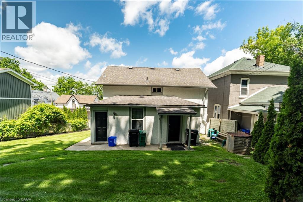 Expansive green lawn with mature perimeter landscaping - 66 Queen Street W, Cambridge, ON