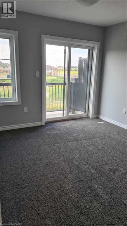 Room featuring dark gray carpeting and light gray walls - 42 Wheat Lane Unit# 42, Kitchener, ON