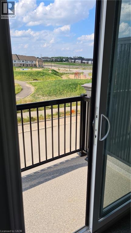 Balcony featuring dark metal railings and a speckled textured surface - 42 Wheat Lane Unit# 42, Kitchener, ON