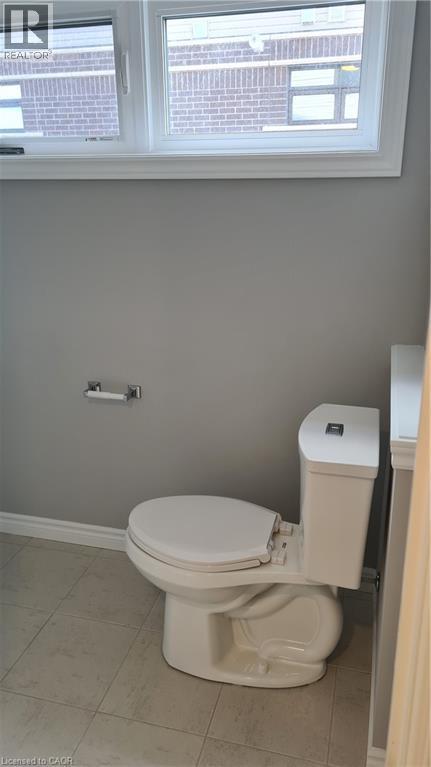 Bathroom featuring a white toilet, light gray painted walls, and light-toned floor tiling - 42 Wheat Lane Unit# 42, Kitchener, ON