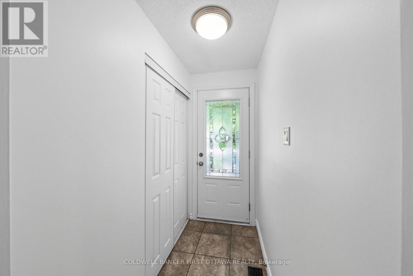 Tiled front foyer w front hall closet. - 12 Bradgate Drive, Ottawa, ON