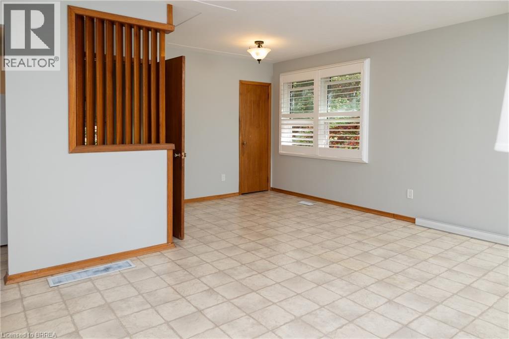 Light gray walls complement the window with white plantation shutters - 156 Mutual Street N, Ingersoll, ON