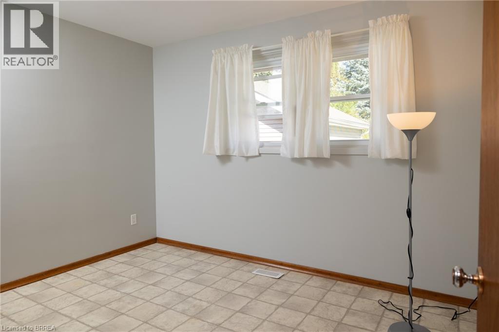 Lower level offering an expansive open area, drop ceiling, and multiple lighting fixtures - 156 Mutual Street N, Ingersoll, ON