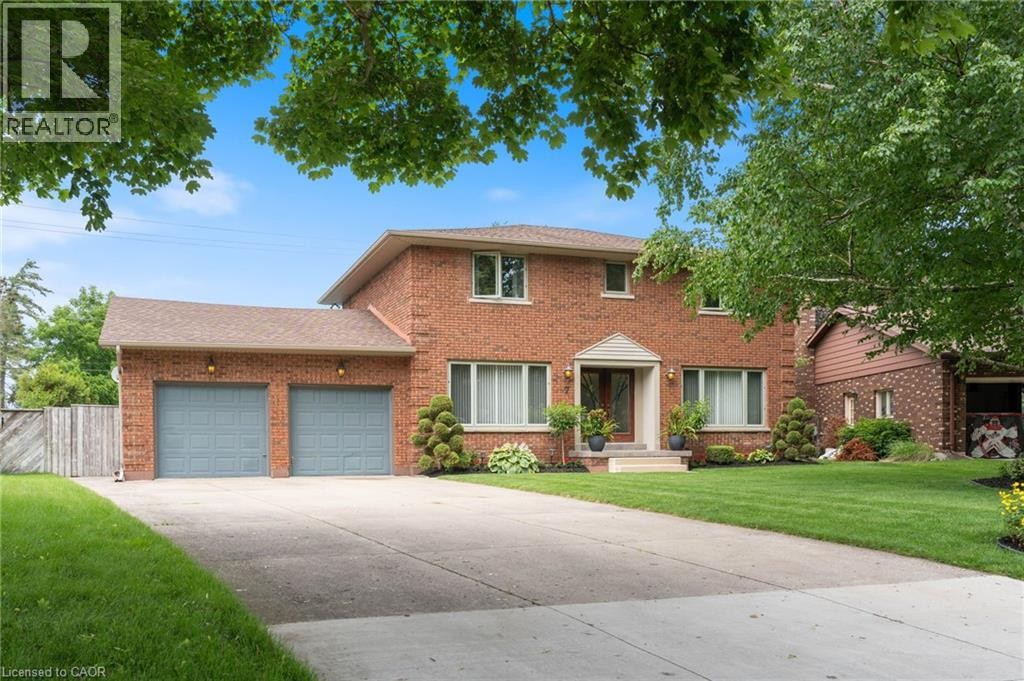 Brick two-story residence featuring a covered front entry with white trim - 7 Thomson Road, Simcoe, ON
