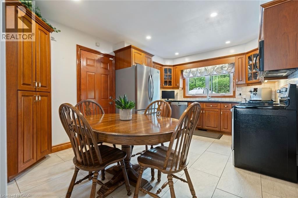 Kitchen featuring wood cabinetry, stainless steel appliances, recessed lighting, and tile flooring - 7 Thomson Road, Simcoe, ON