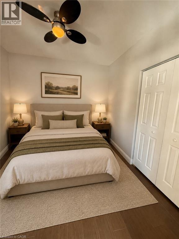 Wood-finish flooring throughout the space - 947 Main Street E, Hamilton, ON - Indoor Photo Showing Bedroom