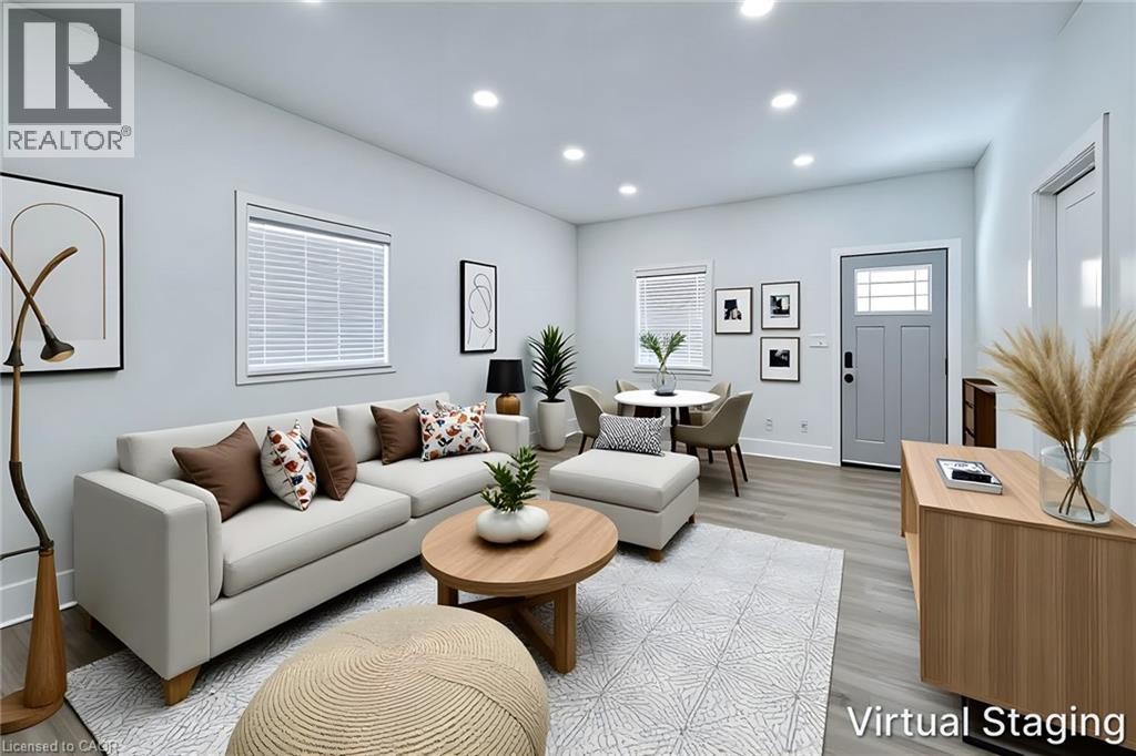 Open-concept living space featuring recessed lighting, wood-finish flooring, and light-toned walls - 78 Hillyard Street, Hamilton, ON