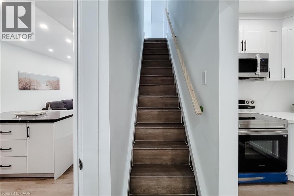 Hardwood-finish staircase with light wood handrail - 78 Hillyard Street, Hamilton, ON