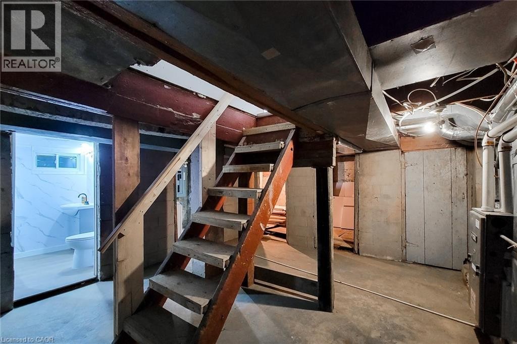 Lower level featuring a three-piece bathroom with white tile walls and a pedestal sink - 78 Hillyard Street, Hamilton, ON