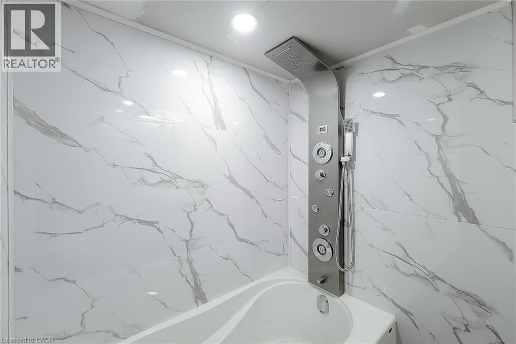 Integrated shower panel with multiple spray functions, handheld shower, and an overhead rainfall showerhead - 78 Hillyard Street, Hamilton, ON