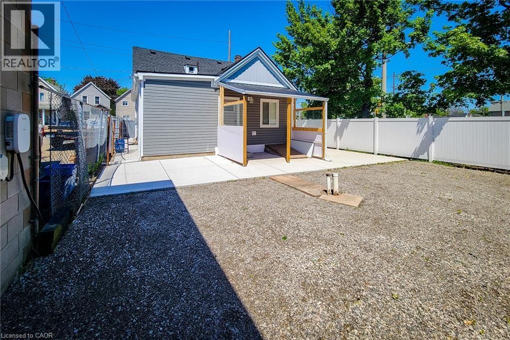 Rear exterior featuring gray siding and white trim - 78 Hillyard Street, Hamilton, ON