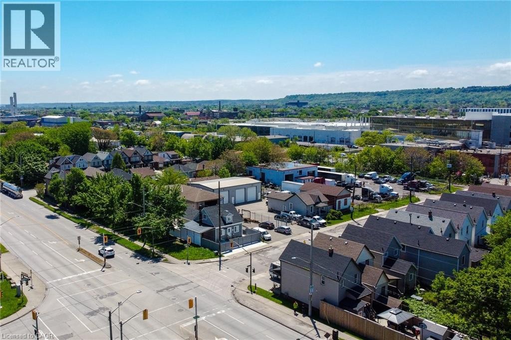 Aerial perspective showcasing a residential area with varied housing styles and mature tree cover - 78 Hillyard Street, Hamilton, ON