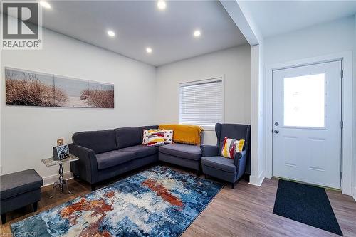 Inviting living space featuring recessed lighting, light-colored walls, and wood-finish flooring - 78 Hillyard Street, Hamilton, ON 