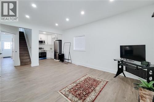 Open concept living area with wood-finish flooring, recessed lighting, and white baseboards - 78 Hillyard Street, Hamilton, ON 