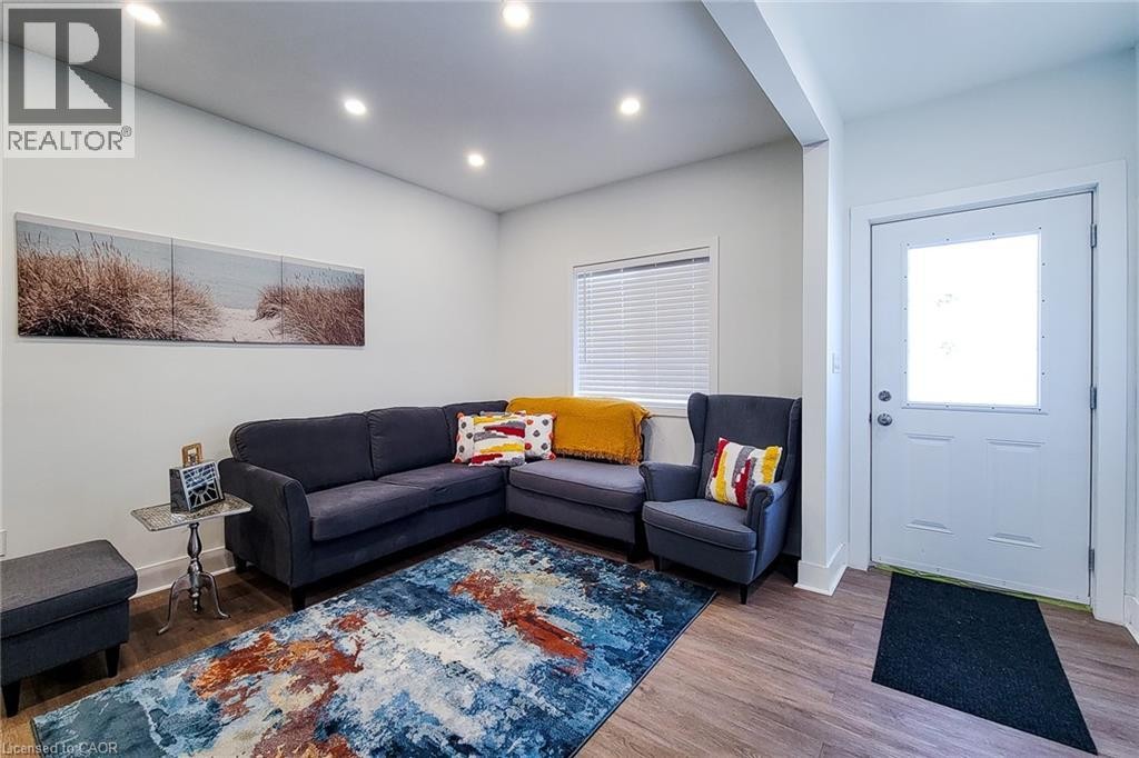 Inviting living space featuring recessed lighting, light-colored walls, and wood-finish flooring - 78 Hillyard Street, Hamilton, ON