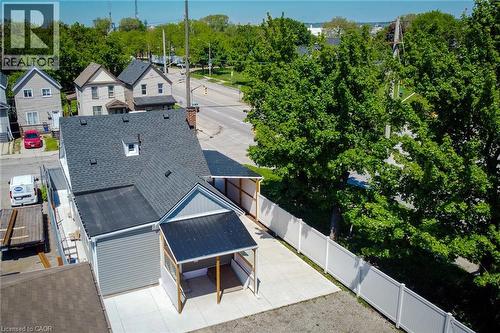 Aerial perspective showcasing a property with a gray shingle roof, light gray siding, and a white privacy fence - 78 Hillyard Street, Hamilton, ON 