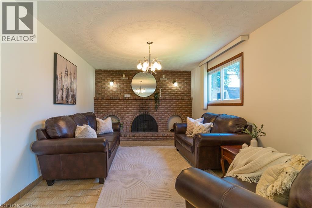 Family room with beautiful wood fireplace - 102 Markson Crescent, Hamilton, ON