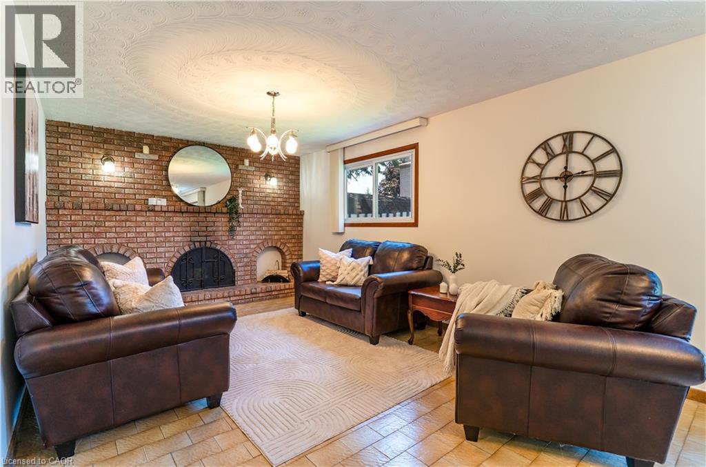Family room with beautiful wood fireplace - 102 Markson Crescent, Hamilton, ON