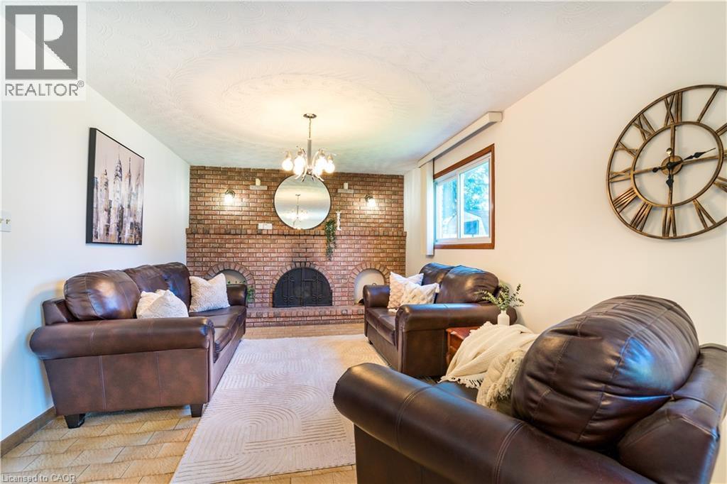 Family room with beautiful wood fireplace - 102 Markson Crescent, Hamilton, ON