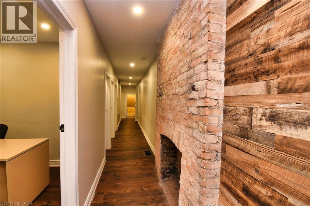 Hallway featuring wood-finish flooring, recessed lighting, and neutral wall paint - 242 James Street S, Hamilton, ON