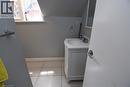 Bathroom featuring a white vanity with an integrated sink, polished chrome faucet, and a rectangular mirror - 242 James Street S, Hamilton, ON 